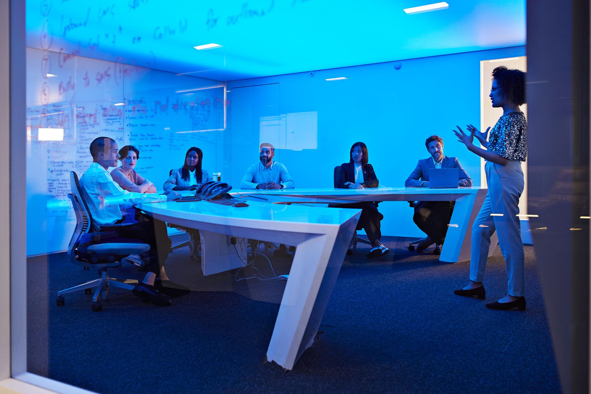 Young businesswoman doing presentation in futuristic board room